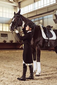 woman jockey with his horse in uniform for Dressage