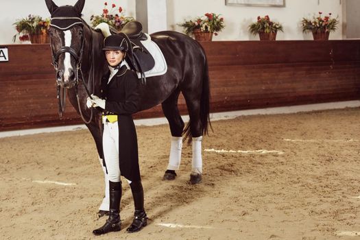 woman jockey with his horse in uniform for Dressage