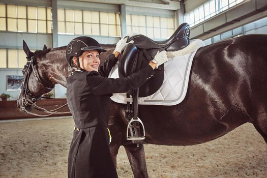 woman jockey with his horse in uniform for Dressage