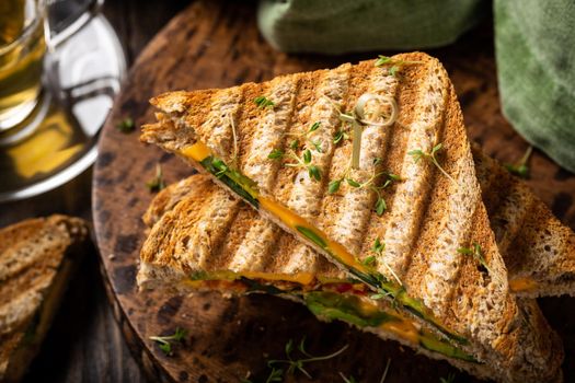 Healthy toasts with avocado, cheddar cheese and tomatoes for breakfast or lunch. Vegetarian sandwiches. Plant-based diet. Whole food concept.