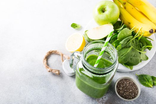 Healthy green smoothie and ingredients. Detox, diet, healthy, vegetarian food concept with copy space. High angle view.