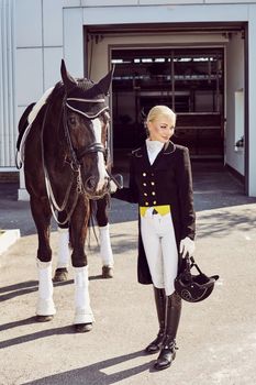 woman jockey with his horse in uniform for Dressage