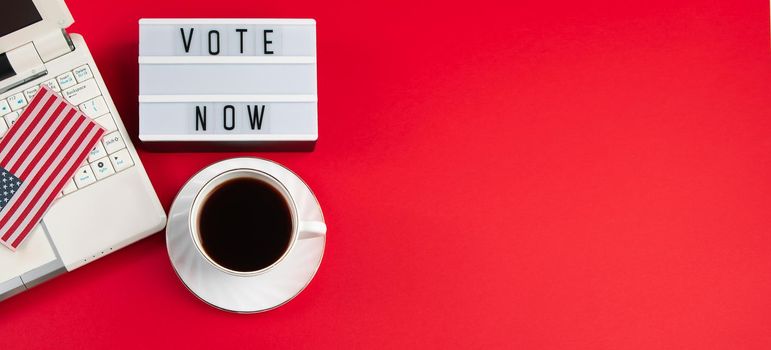 Online voting and elections concept. Laptop and coffee cup on a red background. Banner format