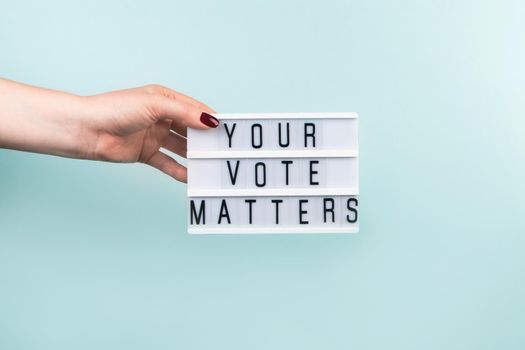 Elections and voting concept. Woman holding white flag on blue background. Place for text.