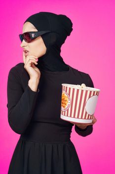 Muslim woman attractive look popcorn glasses movie watching isolated background. High quality photo