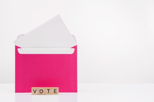 Mail voting concept. Envelope with ballot paper on a white background. Place for text.