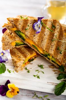 Healthy toasts with avocado, cheddar cheese and tomatoes for breakfast or lunch. Vegetarian sandwiches. Plant-based diet. Whole food concept.