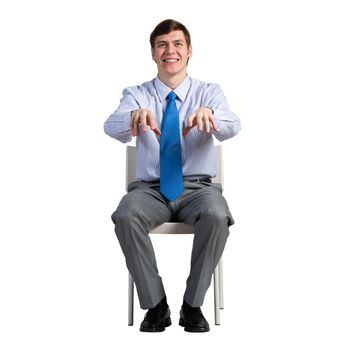 businessman sits on a chair, plays an imaginary piano
