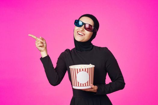 Muslim woman attractive look popcorn glasses movie watching isolated background. High quality photo