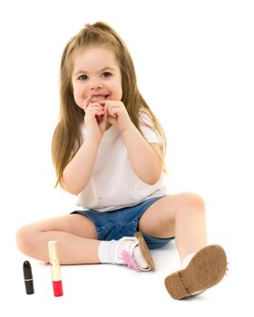 Cheerful little girl paints lips with mom's lipstick. The concept of beauty and fashion, family, advertising. Isolated on white background.