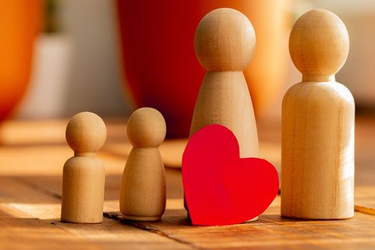 Small wooden figures of family members close up. Family relationship symbol