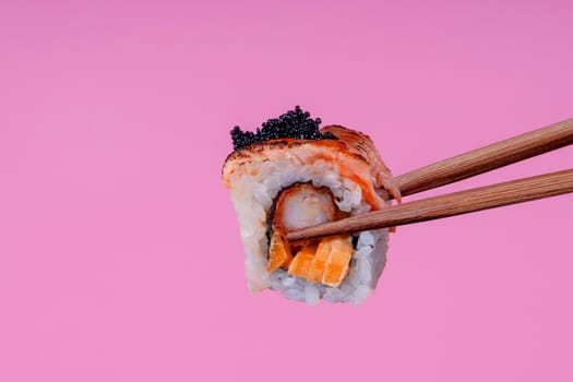 Roll with shrimp and salmon on a pink background