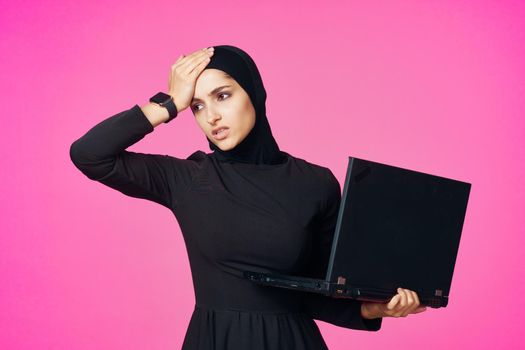 cheerful muslim woman with laptop education student internet technology. High quality photo