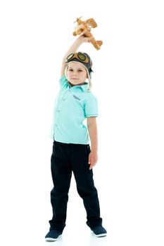 Happy kid boy plays with wooden toy airplane.Isolated on white background.