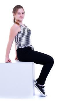 Beautiful teen girl posing in a studio on white in a cube like a banner on which you can make an advertising inscription. The concept of promotion of goods. Isolated on white background.