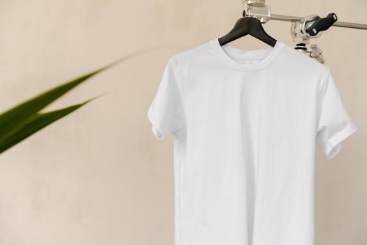 Plain white cotton t-shirt on hanger for your design, copy space