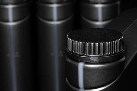 Engine oil bottle on black background.