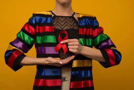 Woman Holds Red Ribbon to awareness world aids day Dec. 1 - image