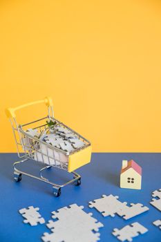 Shopping cart with small house,shopping, rent, loan, mortgage, eco district housing concept.