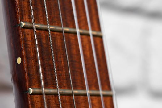 Guitar fingerboard with strings close up photo in dark