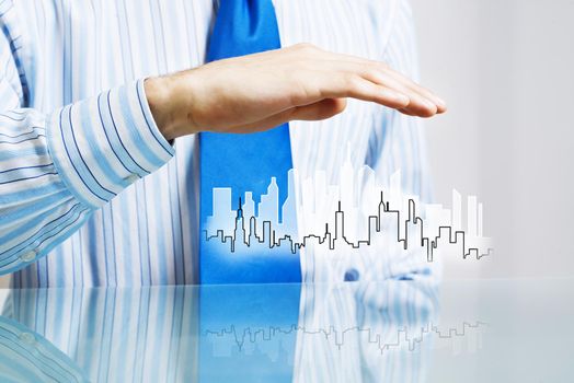 Businessman sitting at table presenting real estate insurance concept
