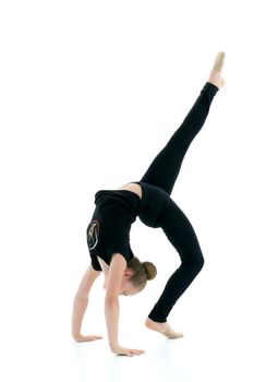 Girl gymnast performs a bridge with a raised leg. The concept of a healthy lifestyle, sport. Isolated on white background.