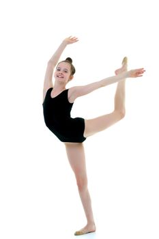 A girl gymnast performs an acrobatic element. The concept of childhood, sport, healthy lifestyle. Isolated on white background.