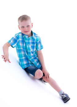 Cute little boy studio portrait on white cyclorama. The concept of a happy childhood. Isolated on white background