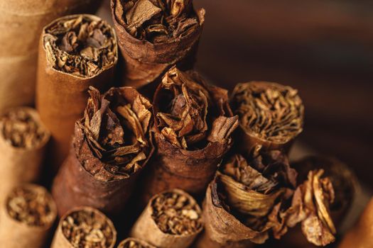 Pile of new cuban cigars close up on wooden table