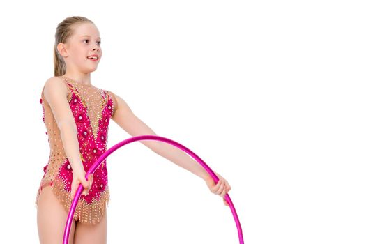 A girl gymnast performs an exercise with a hoop. The concept of gymnastics and fitness. Isolated on white background.