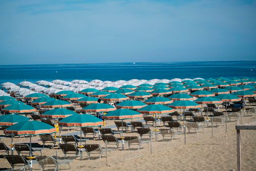 umbrellas open on the seafront of Riccione on the Romagna Riviera. High quality photo