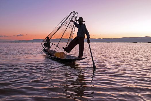 Fishing man on the Inle Lake in Myanmar at sunset