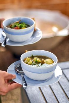 shurpa asian soup with meat and vegetables on wooden table. Copy space for your text.