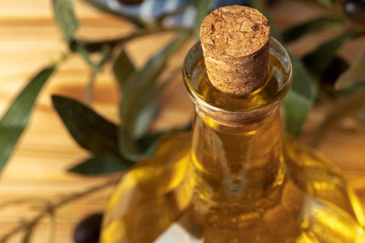 Olive oil bottle on wooden table.
