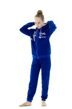 Portrait of a gymnast girl in a tracksuit. Isolated on white background