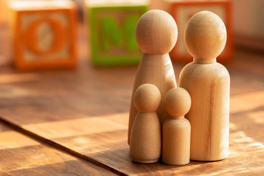 Small wooden figures of family members close up. Family relationship symbol