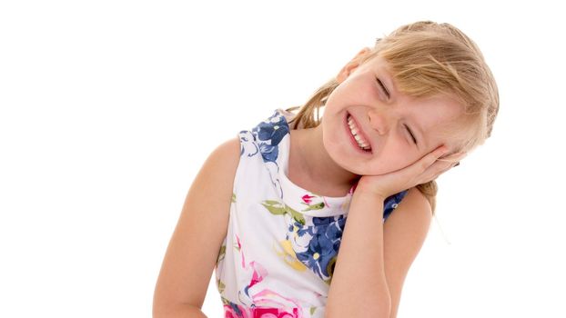 Beautiful little girl posing in the studio. Children's emotions concept. Close-up. Isolated on white background.