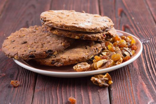Oat cookies served on dark wooden table close up