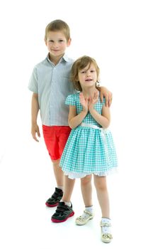 Boy and girl, brother and sister posing in the studio. Concept of family values, friendship, game. Isolated on white background