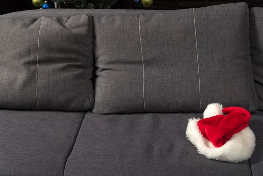 Santa hat on sofa. New Years Eve is over concept.