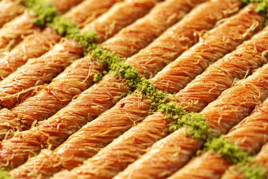 Close up photo of Turkish Baklava dessert with honey and nuts
