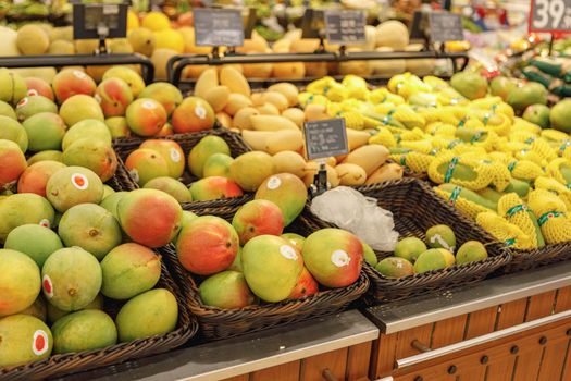 Assortment of fresh fruits on counter in supermarket, close up