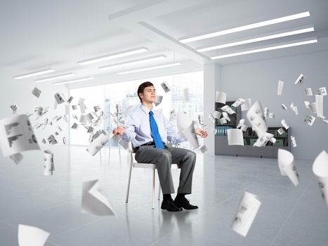 young businessman in the office meditates. concept of creativity