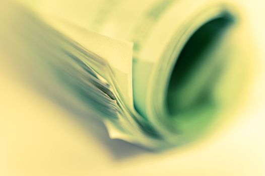 Euro money, Euro cash background. Banknotes of the european union on a white background. Close up. Shallow depth of field. 100 euros roll. Toned.