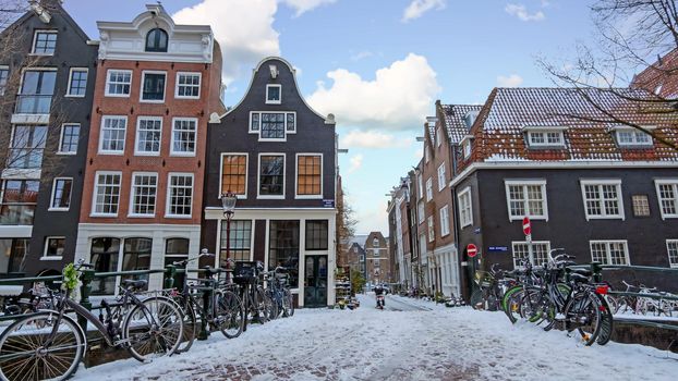 City scenic from snowy Amsterdam in the Netherlands at sunset