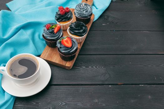 Close up of some decadent gourmet cupcakes frosted with a variety of frosting flavors
