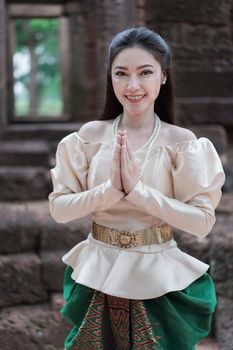 beautiful woman in Thai traditional dress is pay respect