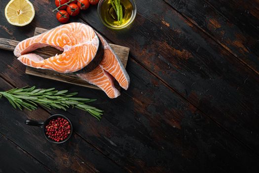 Fesh raw trout fillet with herbs, on old wooden table, top view with space for text.