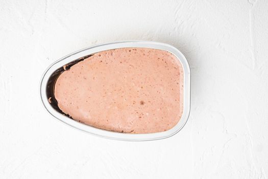 Liver pate, pasty spread in tin can set, on white stone table background, top view flat lay