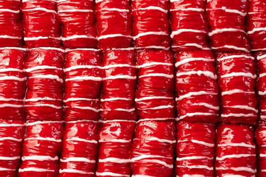 Red colored Turkish dessert baklava placed in rows, for background